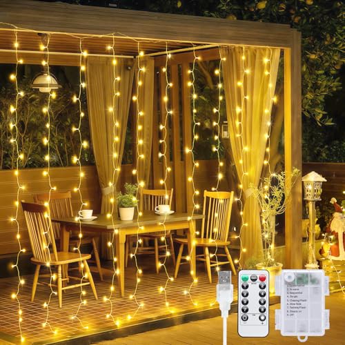 JMEXSUSS 200 LED Christmas Curtain Lights Battery Operated & USB Plug in, 8 Modes Warm White Curtain String Lights for Bac...