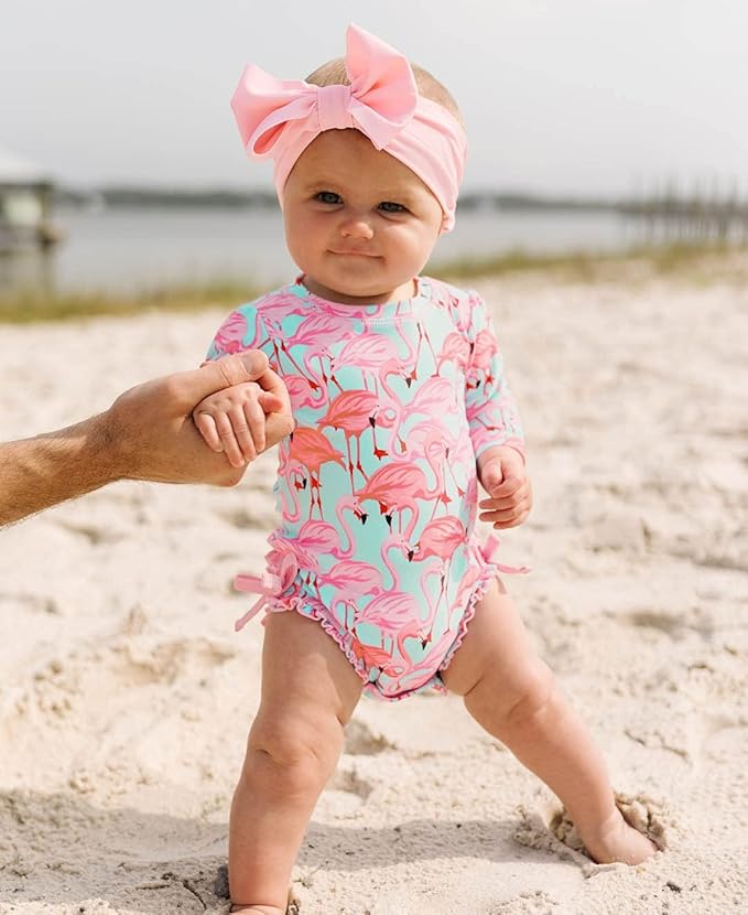 RuffleButts Baby Girls UPF 50+ Sun Protection Novelty Print Long Sleeve One Piece Rash Guard Swimsuit with Zipper