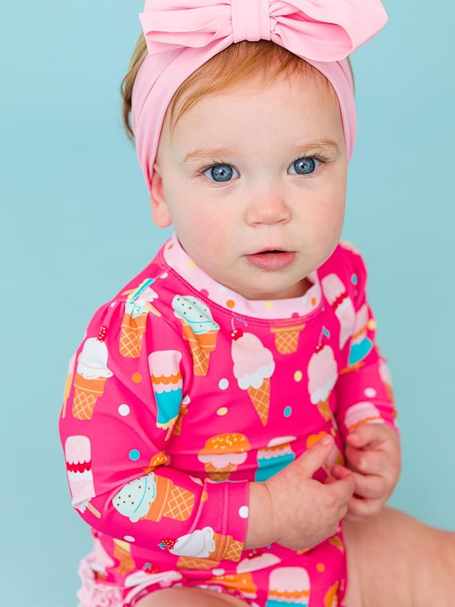 RuffleButts Baby Girls UPF 50+ Sun Protection Novelty Print Long Sleeve One Piece Rash Guard Swimsuit with Zipper