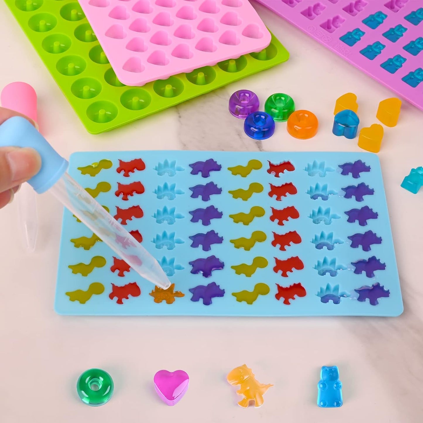 Sakolla Gummy Candy Molds Silicone with 2 Droppers Pack of 4 Mini Silicone Molds Including Dinosaur, Bear Shape, Hearts and Donut Gummie Chocolate Molds for Kids