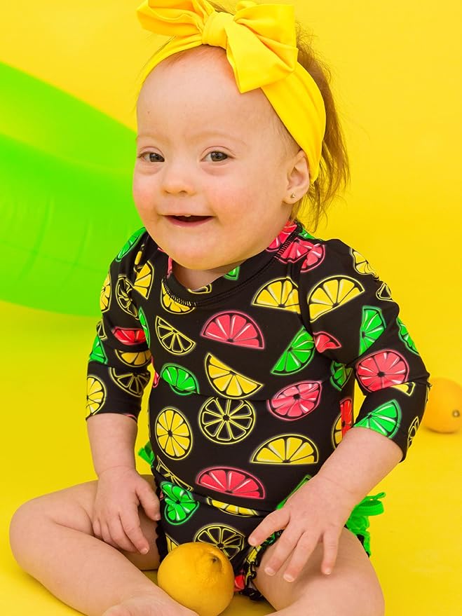 RuffleButts Baby Girls UPF 50+ Sun Protection Novelty Print Long Sleeve One Piece Rash Guard Swimsuit with Zipper