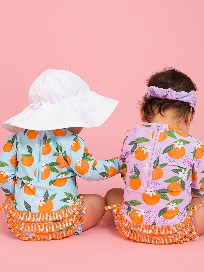 RuffleButts Baby Girls UPF 50+ Sun Protection Novelty Print Long Sleeve One Piece Rash Guard Swimsuit with Zipper