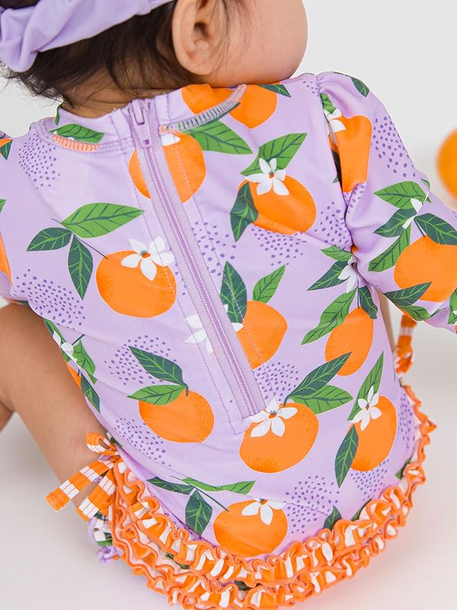 RuffleButts Baby Girls UPF 50+ Sun Protection Novelty Print Long Sleeve One Piece Rash Guard Swimsuit with Zipper